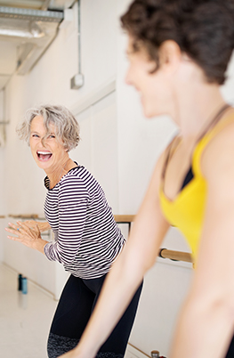 Two women doing exercise class having fun 