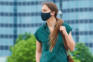 woman standing outside with a facemask on 