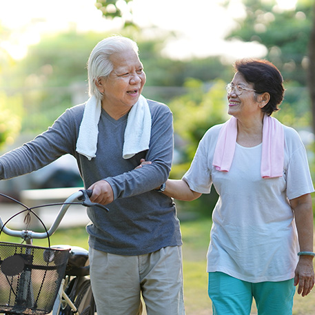 Staying active with exercise Older active couple walking together after exercising