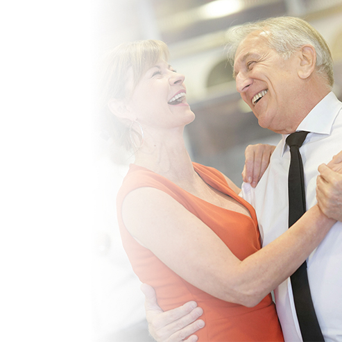 An elderly man and women dancing without feeling body pain