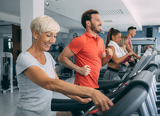 group of people running on treadmills