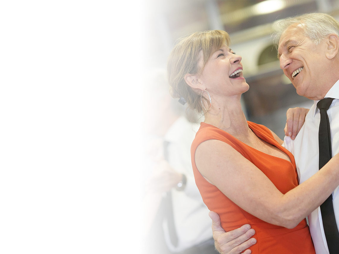 An elderly man and women dancing without feeling body pain